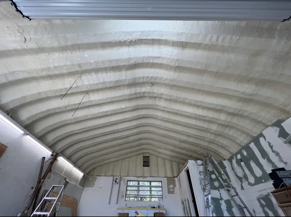 Spray polyurethane foam applied to the underside of a metal roof deck in Elko New Market